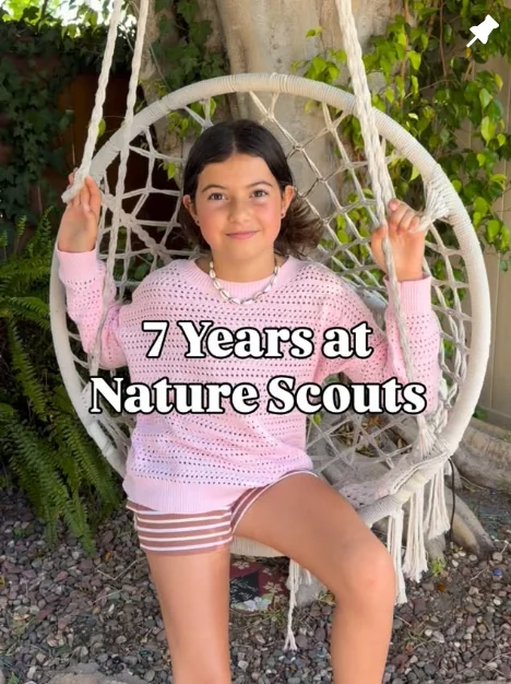 Young girl sitting in a hanging chair with text overlay reading ‘7 Years at Nature Scouts,’ promoting Nature Scouts Collective outdoor learning programs.
