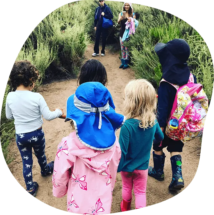 Children walking together on a nature trail during a Nature Scouts Collective outdoor homeschool enrichment program in North County San Diego.