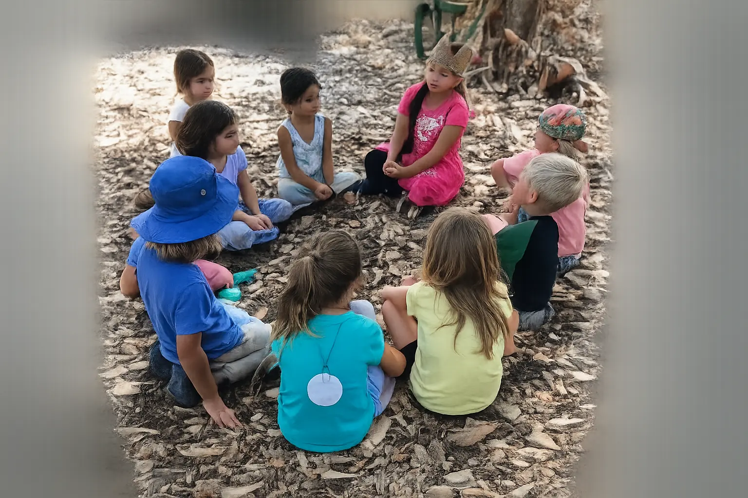 Children sit in a circle outdoors during a Nature Scouts Collective group activity centered on nature-based play, learning and exploration.